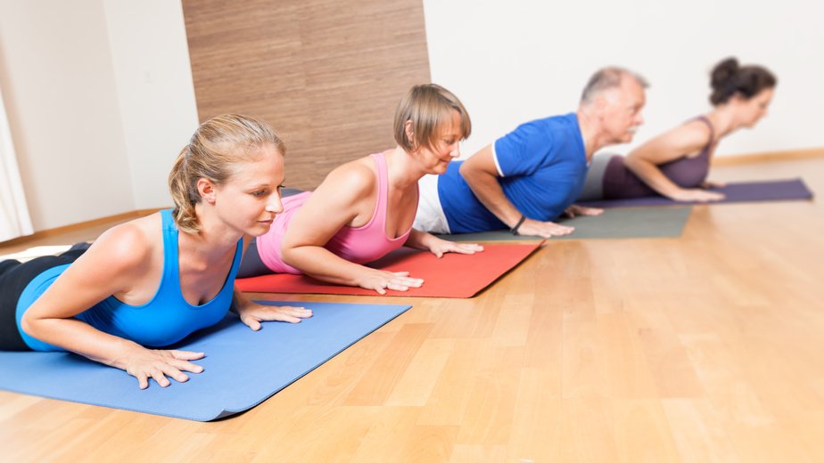 An image of some people doing yoga exercises